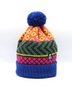 The original Wonky hat, knitted in royal blue, pink, yellow, jade and brown. A royal blue turn up and pompom border the pattern area.