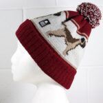 An image of a woman's head wearing the border terrier bobble hat.