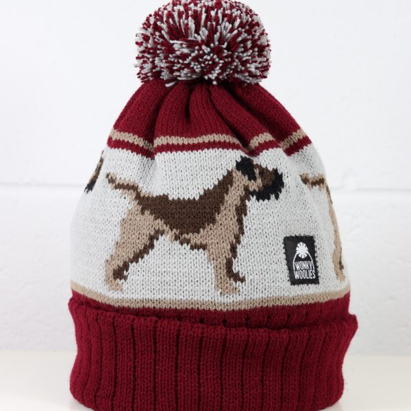 Image of a border terrier dog design on a burgundy bobble hat