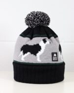Product image of a bobble hat with a border collie dog knitted into it, made by Wonky Woolies.