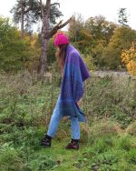 Model lifestyle image wearing a purple blanket scarf like a shawl.